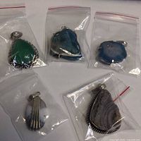 All five stone pendants in individual bags