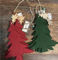 Front view of red and green velvet-front wooden tree ornaments showing jute hangers and glitter mini-tree charms