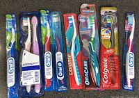 All nine blister-packed toothbrushes laid out side-by-side