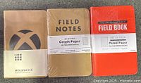 Front view of three sealed notebook packs: Moleskine, Field Notes 3-pack, Field Book 4-pack