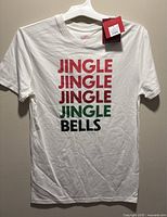 Front view of white tee on hanger showing graphic design and overall condition