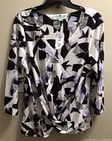 Front view of Cleo abstract print top with tags visible