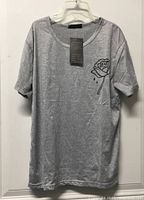 Front of grey t-shirt showing rose graphic and attached tag