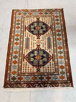 Full view of Turkman rug showing entire design and fringe