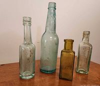 Four mould blown bottles grouped on table