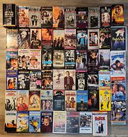 All 60 VHS tapes laid out in grid showing variety of titles