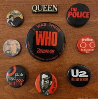 Group shot of all nine buttons and badge