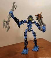 Front view of completed Kiina figure holding trident spear and Thornax launcher