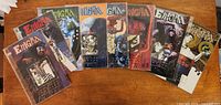 All eight Enigma comics arrayed on tabletop in sleeves