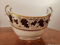 Front view of bone china centrepiece bowl showing grape motif and gilt rim