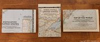 Three folded National Geographic maps front covers