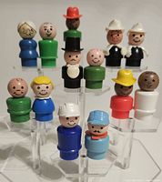 all sixteen Fisher Price Little People on acrylic stand