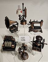 All six bronze-tone miniature pencil sharpeners displayed