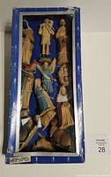 Front view of boxed nativity set with 12 figurines visible through window