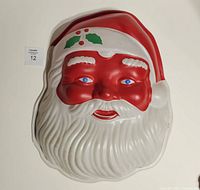 Front view of Santa face blow mold showing color and detail