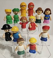 Group image of all 15 Playskool Little People figures on clear tiered stand
