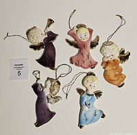 Front view of all five porcelain angel ornaments