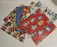 All eight folded sheets fanned out showing various patterns