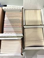 Four set boxes of NHL trading cards arranged upright with card edges visible in two boxes