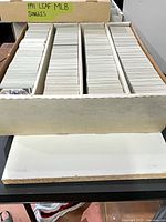 Long storage box with several rows of stacked trading cards