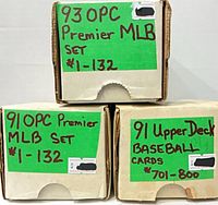 Three labelled cardboard boxes containing the 1991 OPC Premier, 1991 Upper Deck, and 1993 OPC Premier baseball card sets