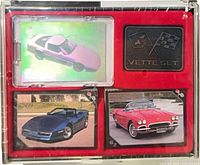 Overall view of sealed Vette Set showing hologram card, badge and two sample cards in red display.