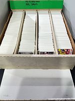Long cardboard storage box divided into rows filled with hockey trading cards