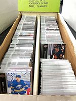 Two-row box filled with hockey cards, label "2021/22 U.D Extended Series NHL Singles" visible