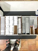 Top-down view of five-row card storage box packed with Dragon Ball trading cards
