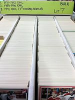 Long storage box with rows of unsleeved trading cards