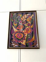 Front view of framed abstract needlepoint