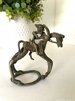 Full view of cast bronze horse and rider sculpture