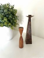 Front view of teak and olive wood candlesticks