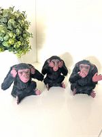 All three goat fur monkey figurines seated together