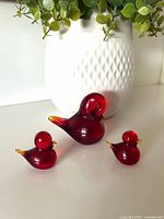 Three amberina glass bird figurines displayed together