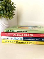 Four hardcover reference books stacked side view showing spines