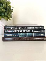 Stack of four hardcover design books spines visible
