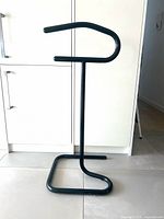 Full view of black metal valet stand showing overall design