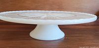 Side profile of white milk glass pedestal cake plate