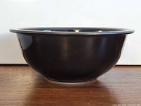 Side profile of black Pyrex mixing bowl showing clear base