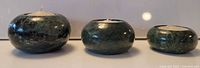 Front view of three green marble tealight holders