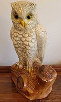 Front view of chalkware owl bank showing detailed feathers, eyes, stump base