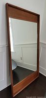 Front view of full-length mirror with wood frame