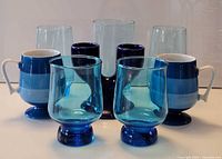 Front view of entire blue glass and mug group