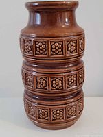 Front view of brown Scheurich vase showing relief floral bands