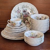full set stacked showing platter, plates, bowls, saucers and teacup