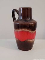 Front view of brown and red West German pottery jug