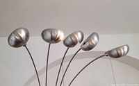 Close-up of five brushed metal dome shades