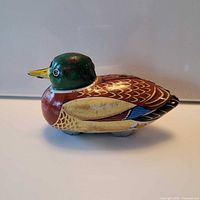 Left side view of entire tin duck toy