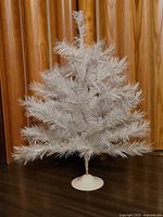 Full view of white tabletop tree on base